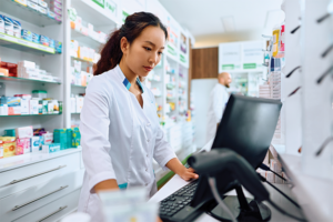 Female pharmacist looking at medication incident on computer screen