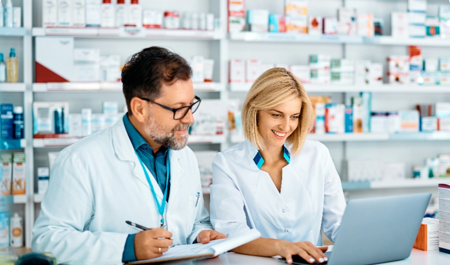 Two pharmacists looking at a computer