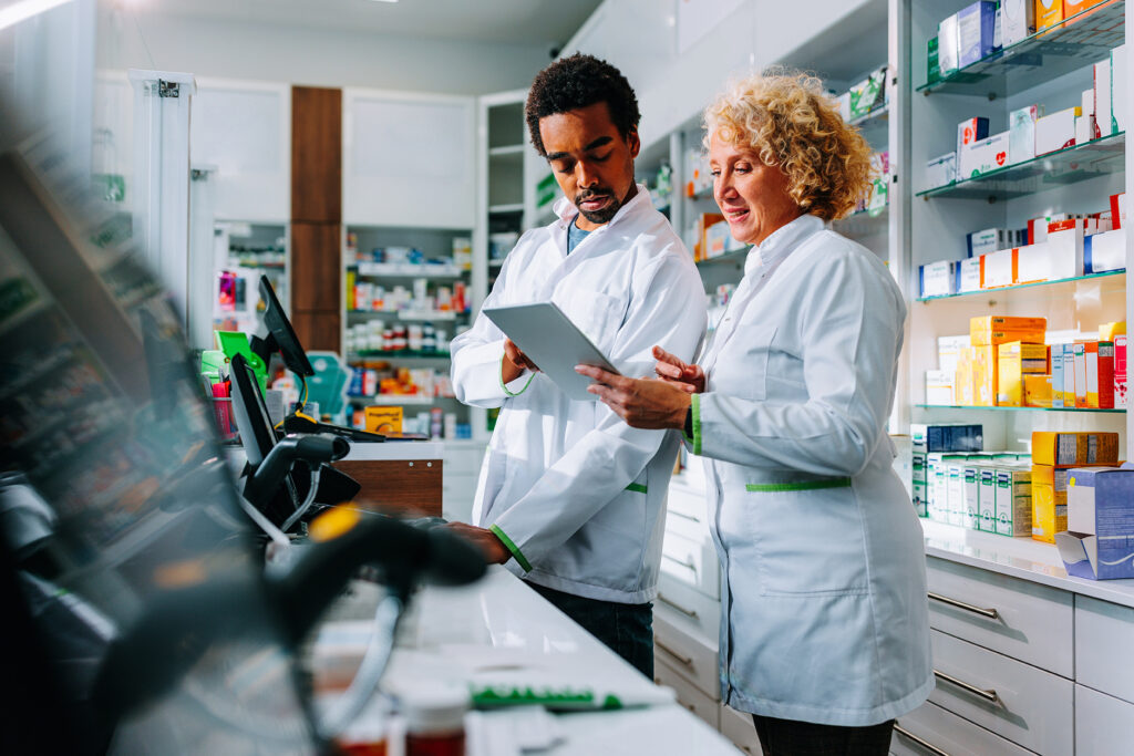 Two pharmacists looking at a computer