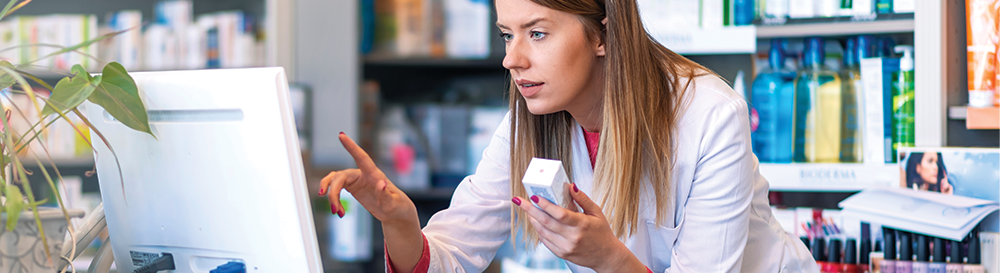 Pharmacist checking something on computer